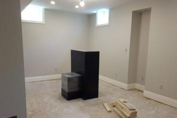 basement rool with white baseboards
