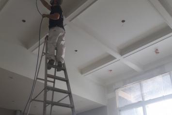 One of our employees painting the ceiling